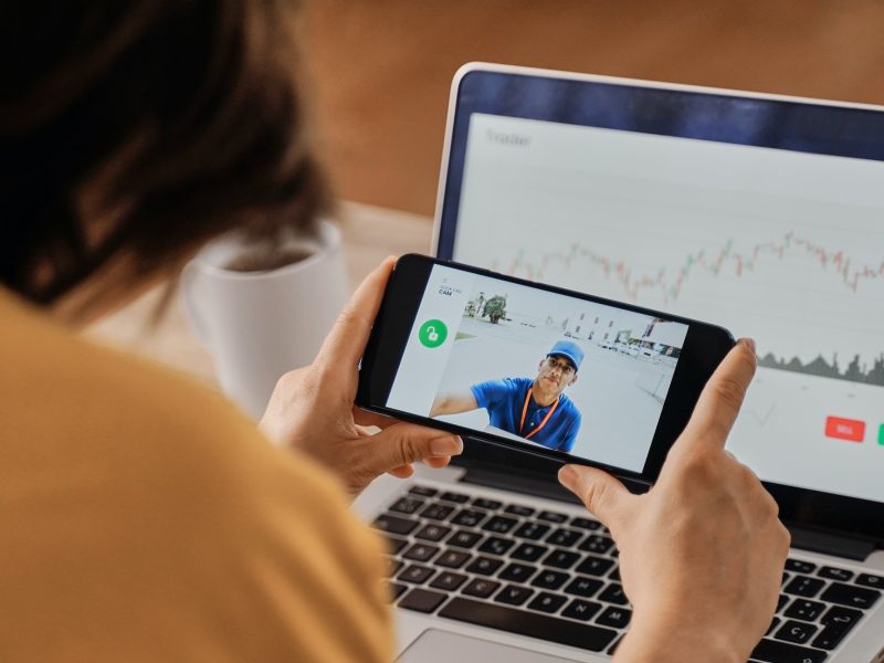 woman-watching-delivery-man-on-security-camera-video-on-mobile-phone-while-working-at-home-office.jpg